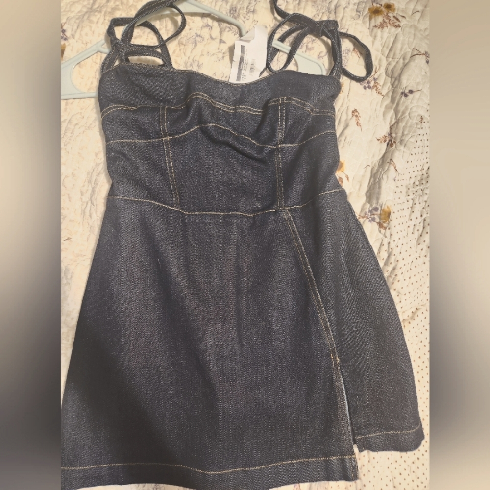 Denim romper, tie straps. Zip up back size medium.